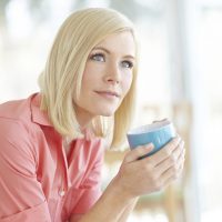 Woman holding cup of coffee