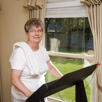 An older woman receiving elderly care in Syracuse participates in treadmill therapy.