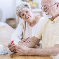 elderly husband and wife contemplating medications and supplements