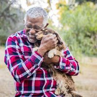 senior-man-loving-on-pet-dog