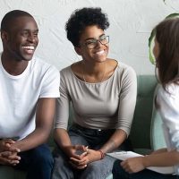 happy couple talking with caregiver