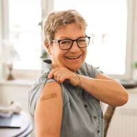 senior-woman-showing-bandage-on-arm