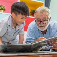 grandchild-and-grandpa-reading-book