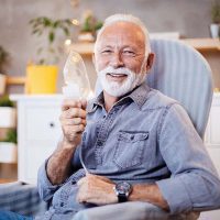 happy-senior-man-holding-oxygen-mask