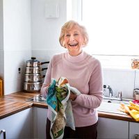 A woman dries dishes to practice independence in seniors with dementia.