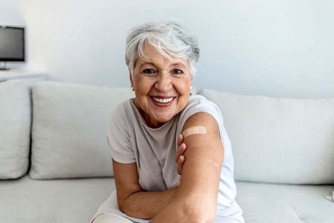 A woman smiles and shows off the bandage on her arm that’s related to a treatment option bringing new hope in Alzheimer’s care.