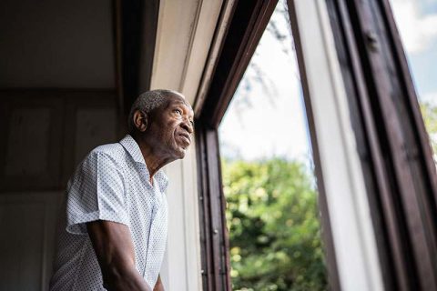 A man with memory loss gazes out the window.