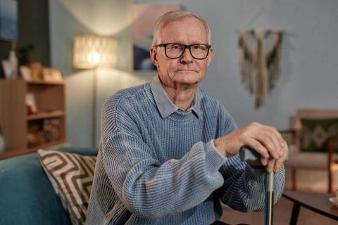 A man experiencing dementia changes stares pensively ahead.